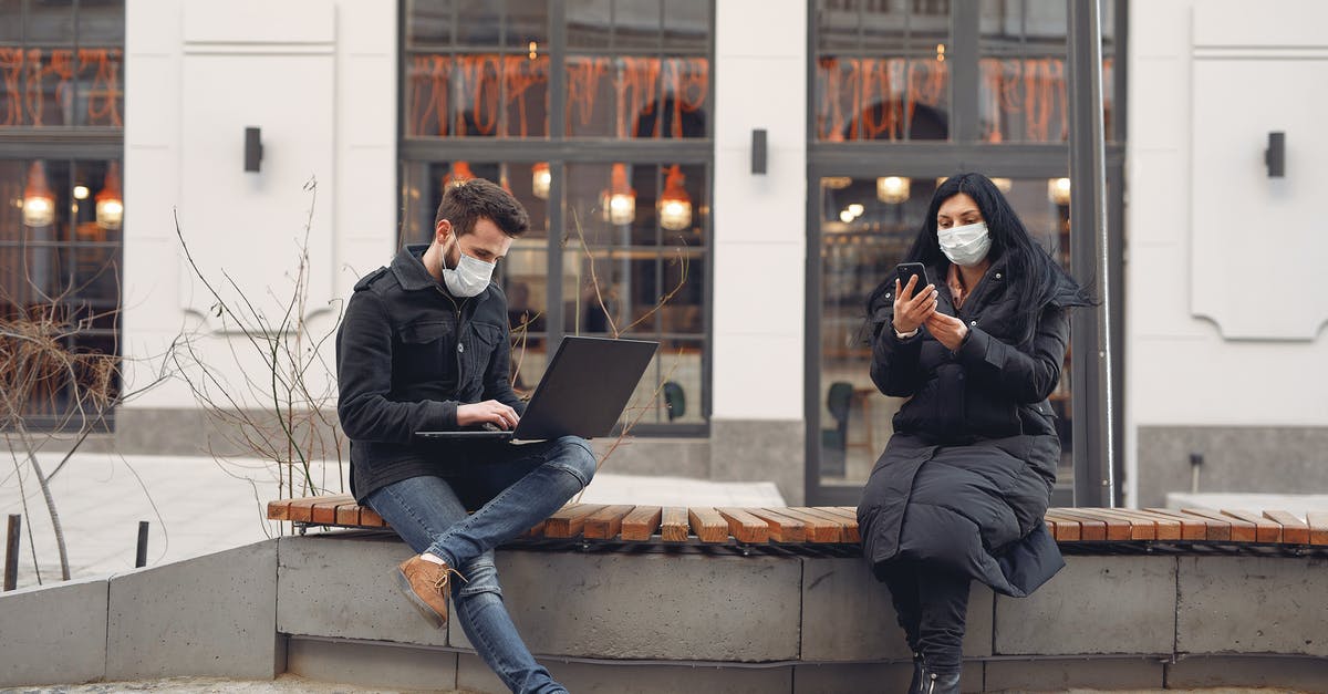 How warm must dough be in order to rise? - Young couple wearing medical masks with laptop and smartphone on city street How warm must dough be in order to rise? - Young couple wearing medical masks with laptop and smartphone on city street