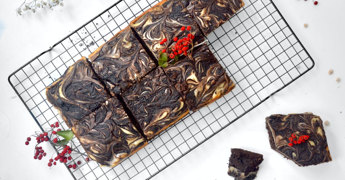 How-to Cut Baking Chocolate bar clean for perfect squares - Top view of appetizing chocolate brownie cut into squares and decorated with ripe berries placed on metal grid on table How-to Cut Baking Chocolate bar clean for perfect squares - Top view of appetizing chocolate brownie cut into squares and decorated with ripe berries placed on metal grid on table