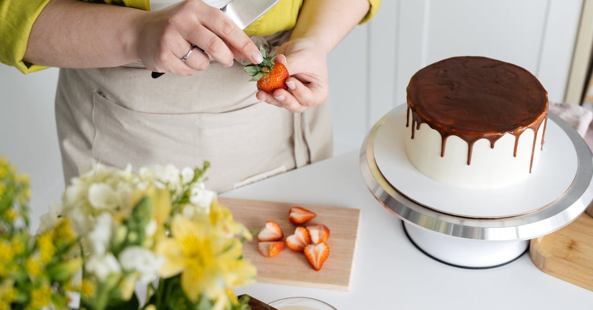 How-to Cut Baking Chocolate bar clean for perfect squares - Woman cutting strawberry for decoration of cake How-to Cut Baking Chocolate bar clean for perfect squares - Woman cutting strawberry for decoration of cake
