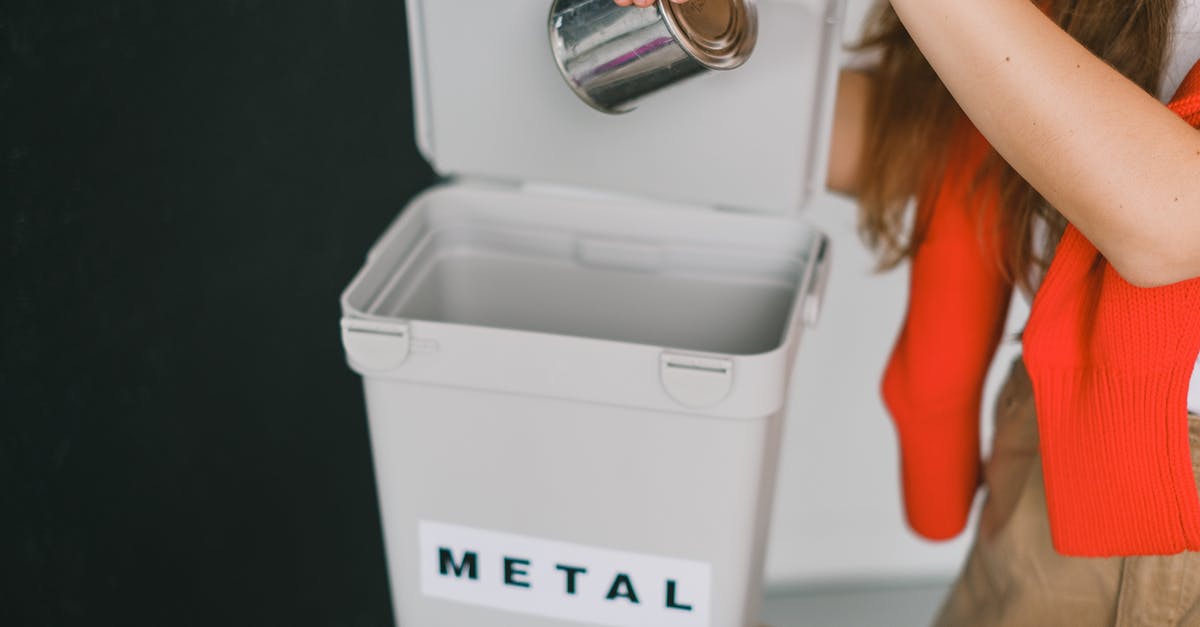 I accidentally put my canned tuna in the fridge - Woman sorting garbage and putting metal can into bucket I accidentally put my canned tuna in the fridge - Woman sorting garbage and putting metal can into bucket