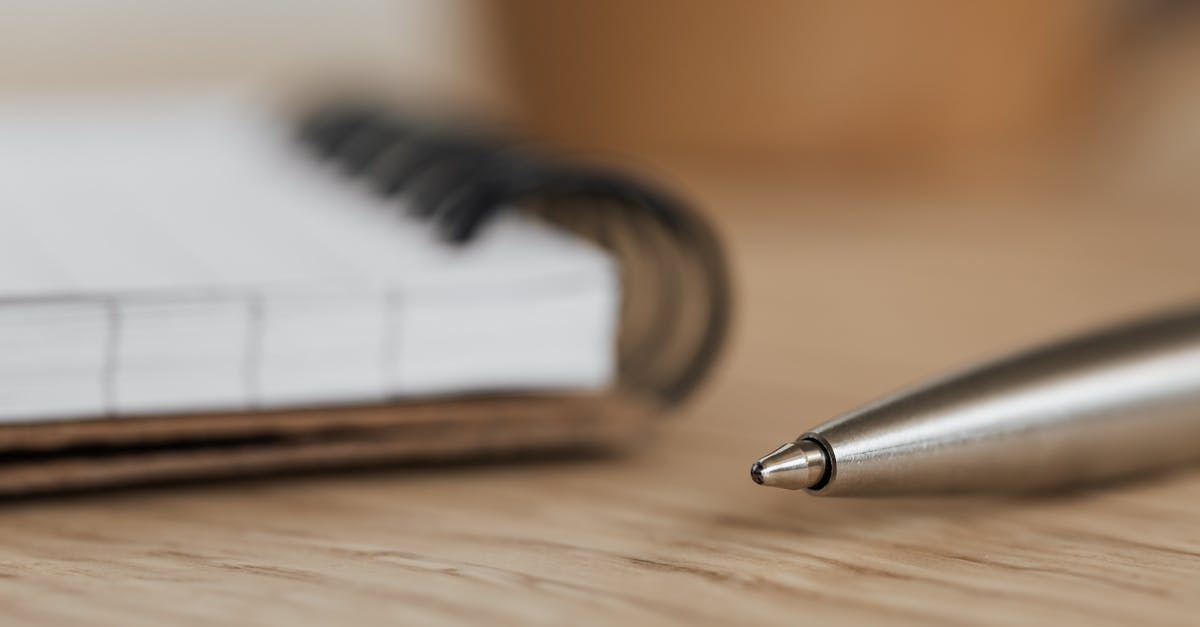 I am trying to design a pie, but I'm not sure what to take into consideration [closed] - Side view closeup of opened ring bound notebook with blank pages near silver ball point pen placed on wooden table