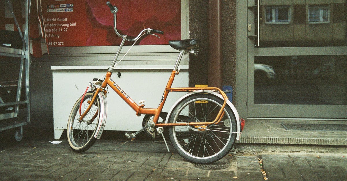 I have an old pyrex bowl with a detachable handle with a glass inset - From above of aged bike with leather seat parked on shabby tiled street pavement near glass door reflecting building with windows in city in daylight