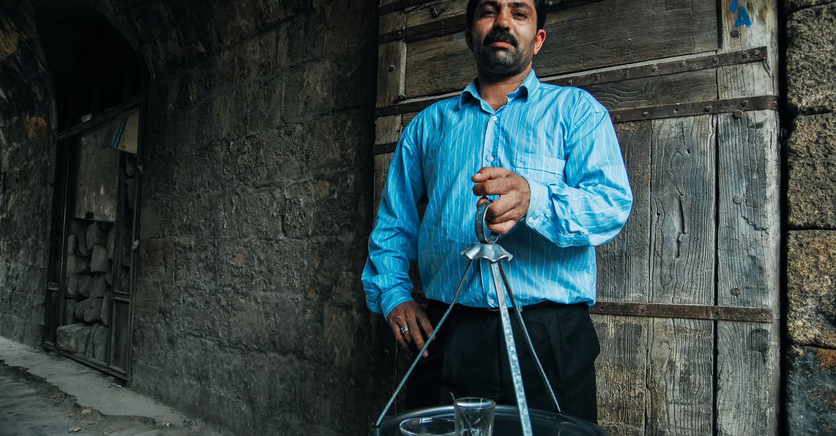 I have an old pyrex bowl with a detachable handle with a glass inset - Stylish bearded ethnic man with tray in old house