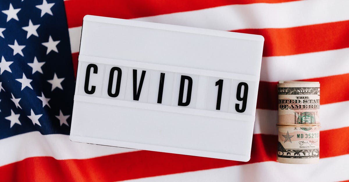 I moved to US recently from India and I am looking for Plastic jars for storage, - From above of plastic signboard with COVID 19 inscription on flag of USA and roll of paper money during financial crisis I moved to US recently from India and I am looking for Plastic jars for storage, - From above of plastic signboard with COVID 19 inscription on flag of USA and roll of paper money during financial crisis