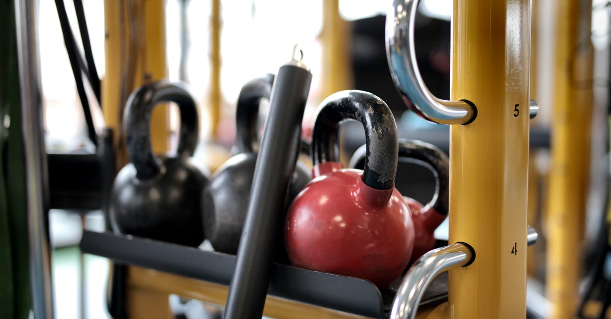 I removed some of the black metallic covering of my pan, is it still safe to use? [duplicate] - Set of different kettlebells placed in row on metal platform on modern fitness equipment in sport center