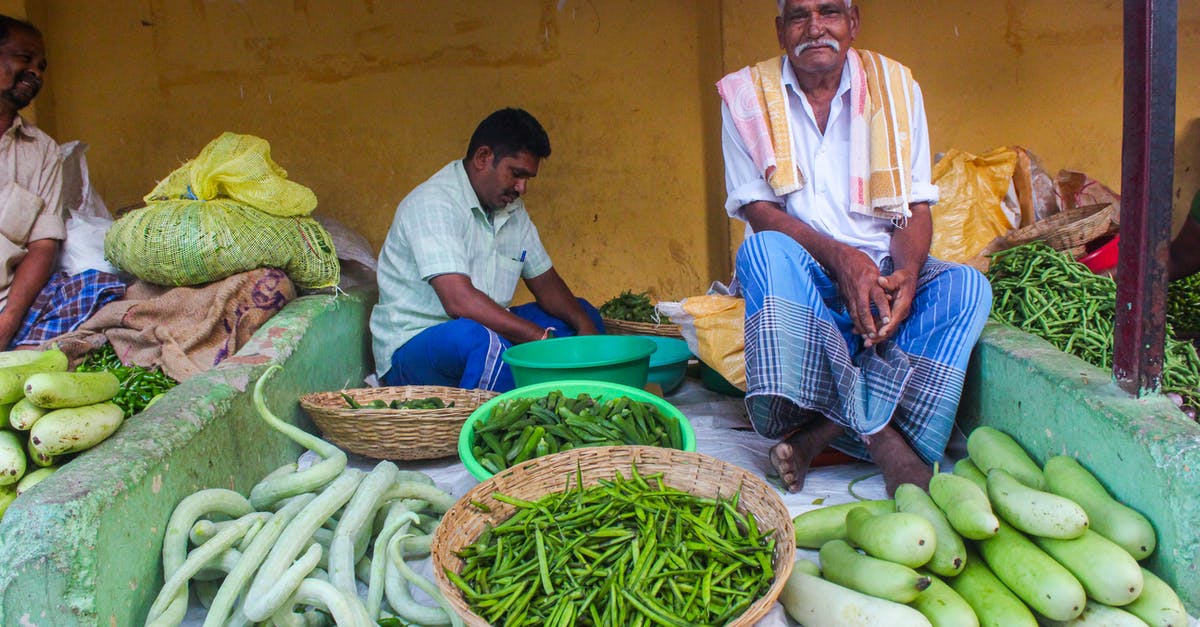 Identifying quality fruits/vegetables at a farmers market - Men Selling Fresh Vegetables Identifying quality fruits/vegetables at a farmers market - Men Selling Fresh Vegetables