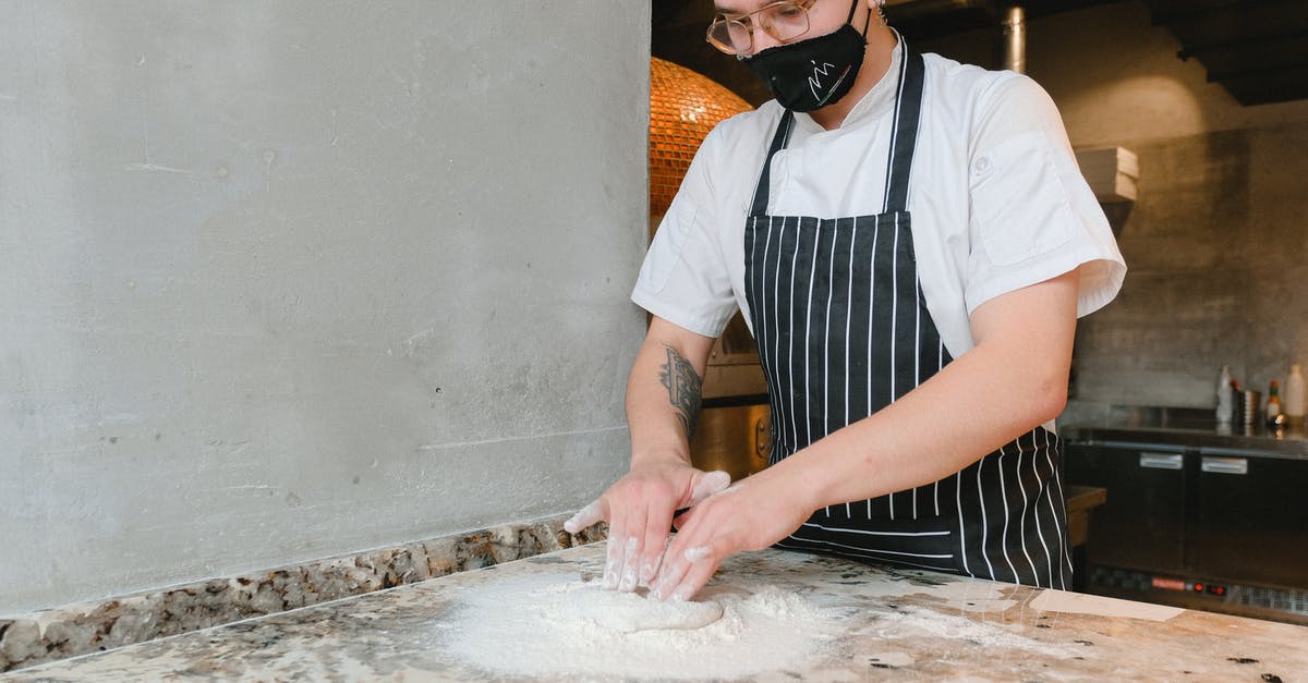If I have much lower than normal humidity, how should I change the amount of flour that dough needs? - Man Holding Flour and Dough If I have much lower than normal humidity, how should I change the amount of flour that dough needs? - Man Holding Flour and Dough