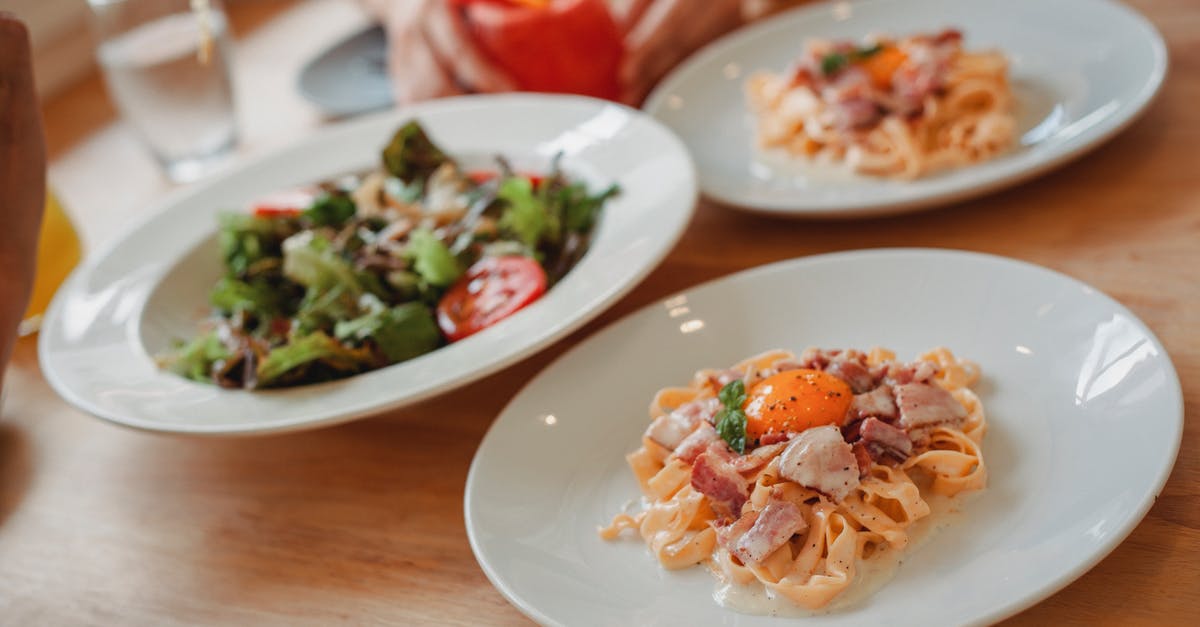 Impact of using egg yolks vs whites in a spaghetti dish? - Delicious pasta and salad on table Impact of using egg yolks vs whites in a spaghetti dish? - Delicious pasta and salad on table