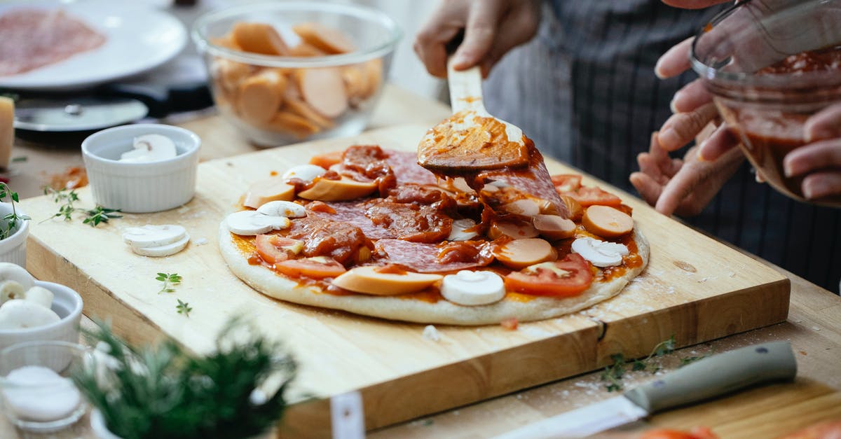 In a tomato sauce recipe, how can I cut the acidity? - Crop people adding sauce on pizza In a tomato sauce recipe, how can I cut the acidity? - Crop people adding sauce on pizza