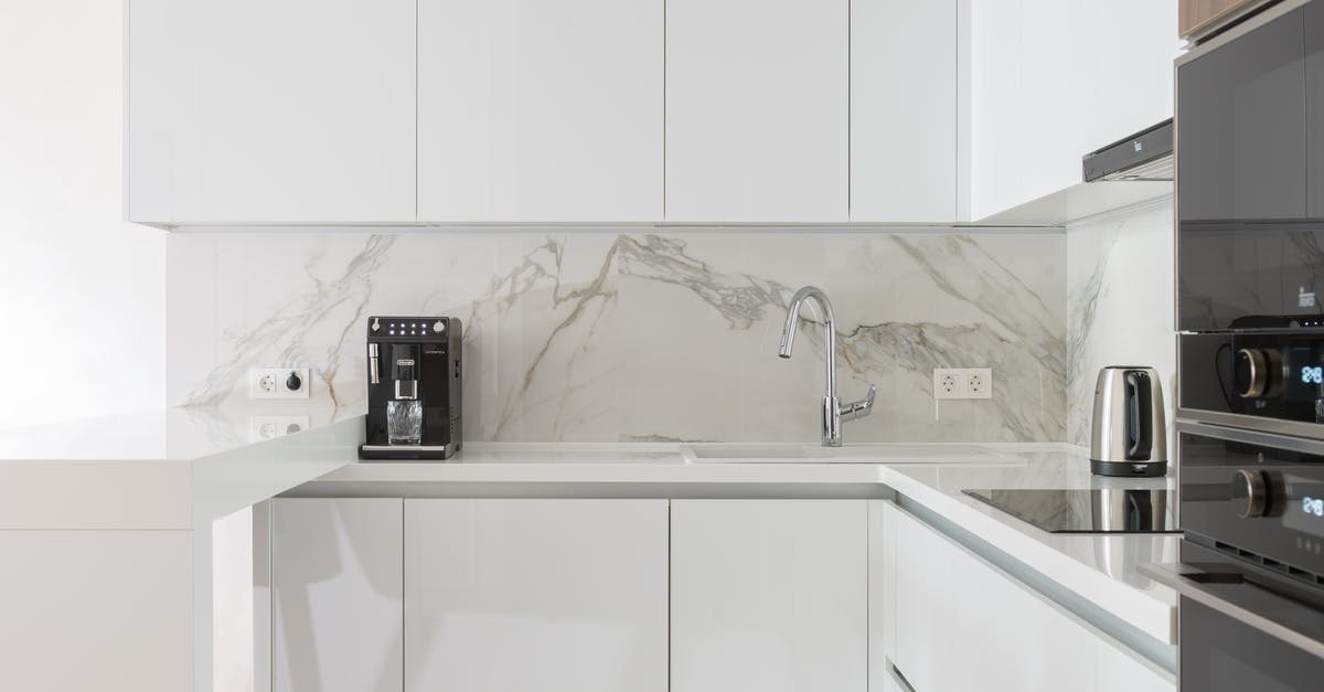 Induction cooker on a wooden table? - Modern kitchen interior with furniture and appliances Induction cooker on a wooden table? - Modern kitchen interior with furniture and appliances