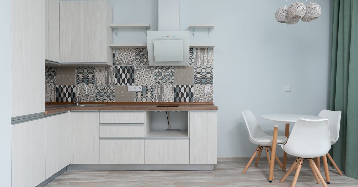 Induction cooker on a wooden table? - Interior of modern kitchen with table Induction cooker on a wooden table? - Interior of modern kitchen with table