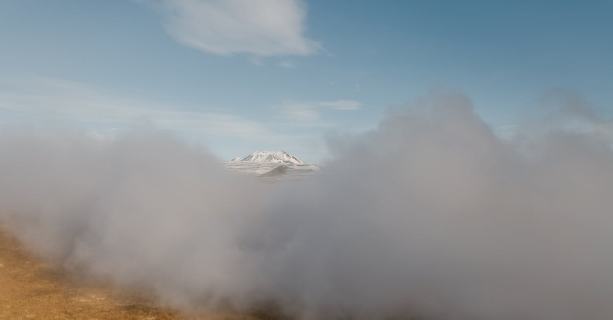 Induction range vs gas - Scenery of dense gray clouds covering spacious mountainous valley against clear blue sky Induction range vs gas - Scenery of dense gray clouds covering spacious mountainous valley against clear blue sky
