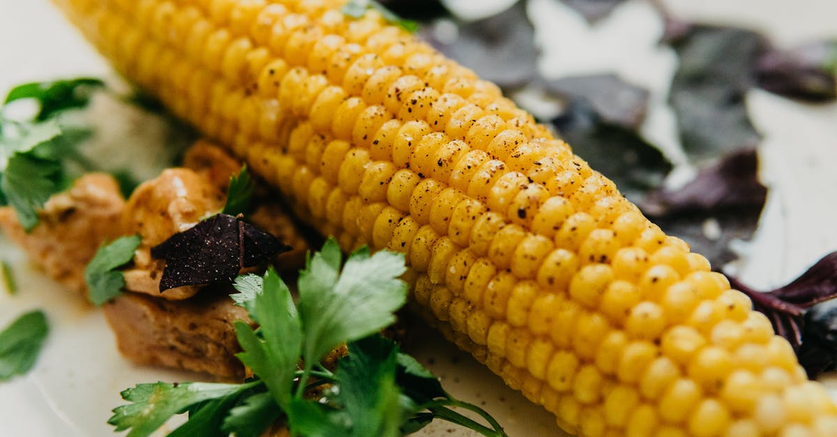 Ingredient Identification: Hong Kong restaurant spicy spice - Tasty boiled corn cob served on table with herbs Ingredient Identification: Hong Kong restaurant spicy spice - Tasty boiled corn cob served on table with herbs