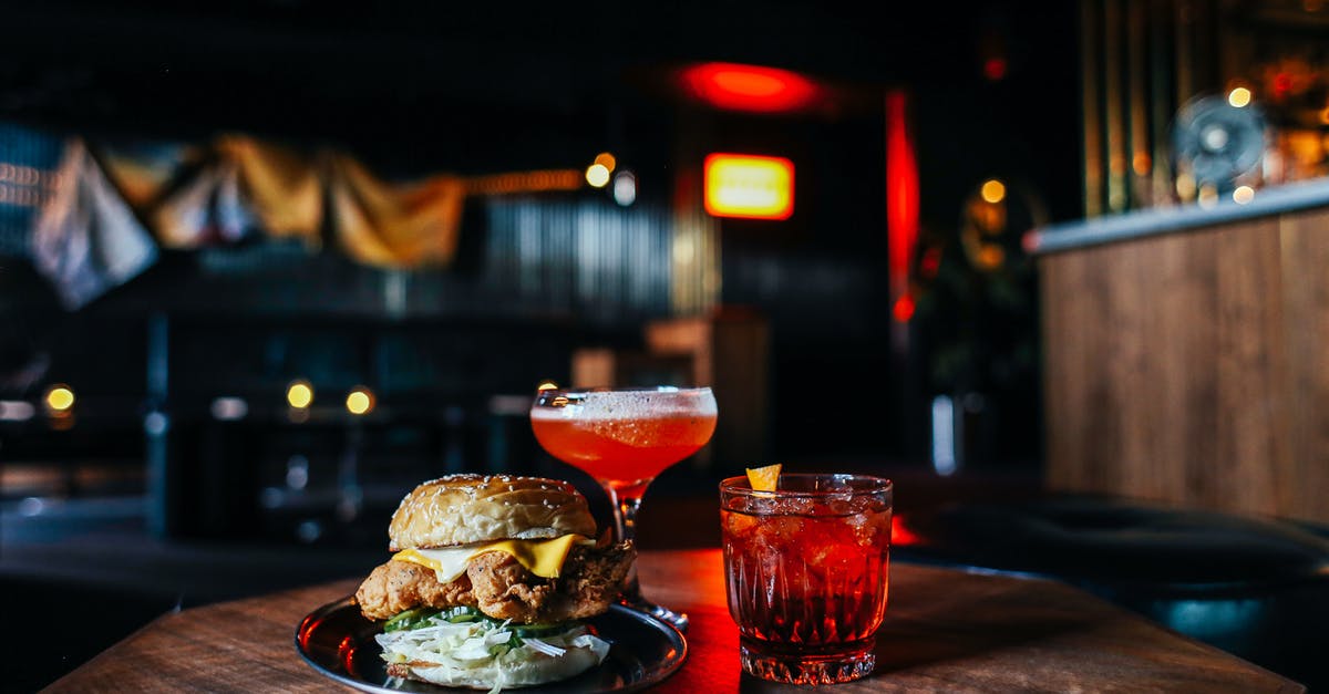 Ingredient to counter ammonia aroma/taste - Delicious hamburger with cocktails on table Ingredient to counter ammonia aroma/taste - Delicious hamburger with cocktails on table