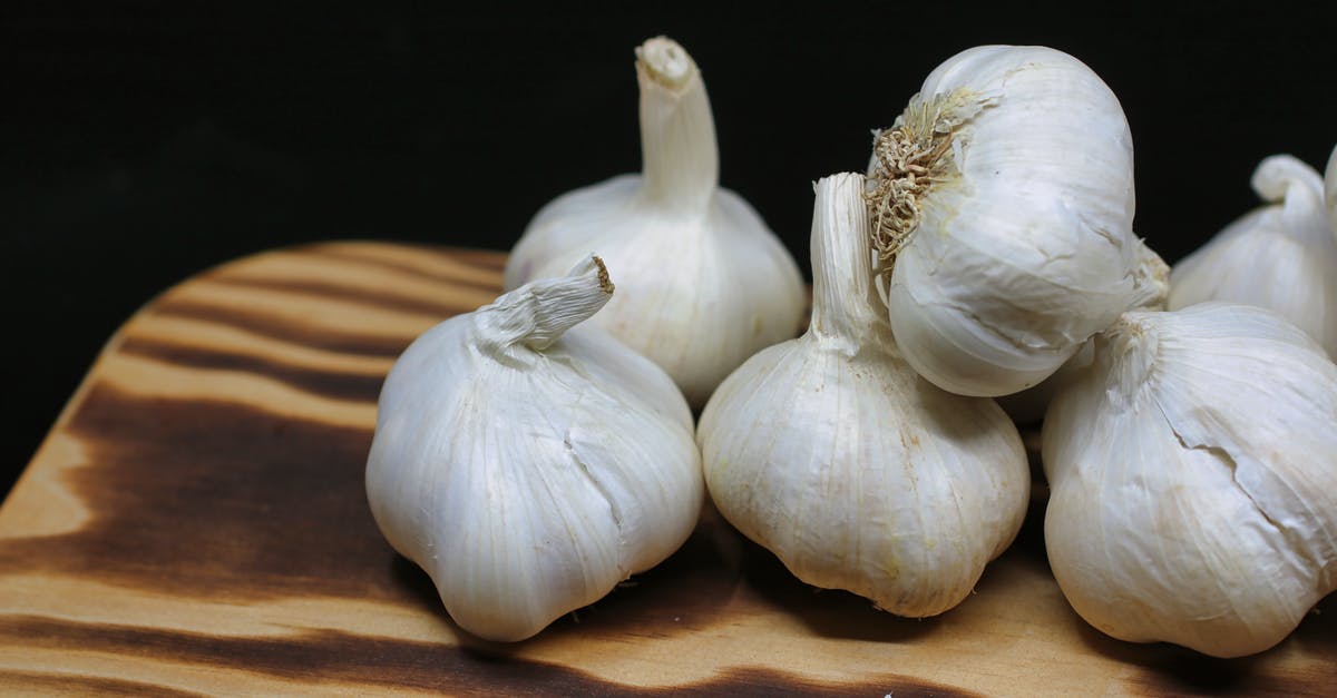 Ingredients of Root Beer - Garlic Bulbs on Brown Surface Ingredients of Root Beer - Garlic Bulbs on Brown Surface