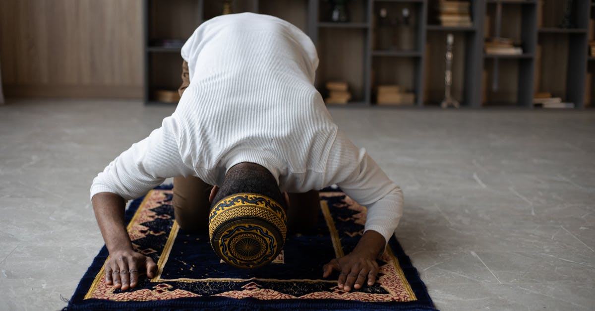 Interruption in canning process - Muslim black man praying at home Interruption in canning process - Muslim black man praying at home