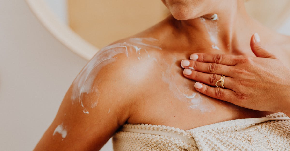 Irish Cream Manufacturing - Woman Putting Cream on Skin Irish Cream Manufacturing - Woman Putting Cream on Skin