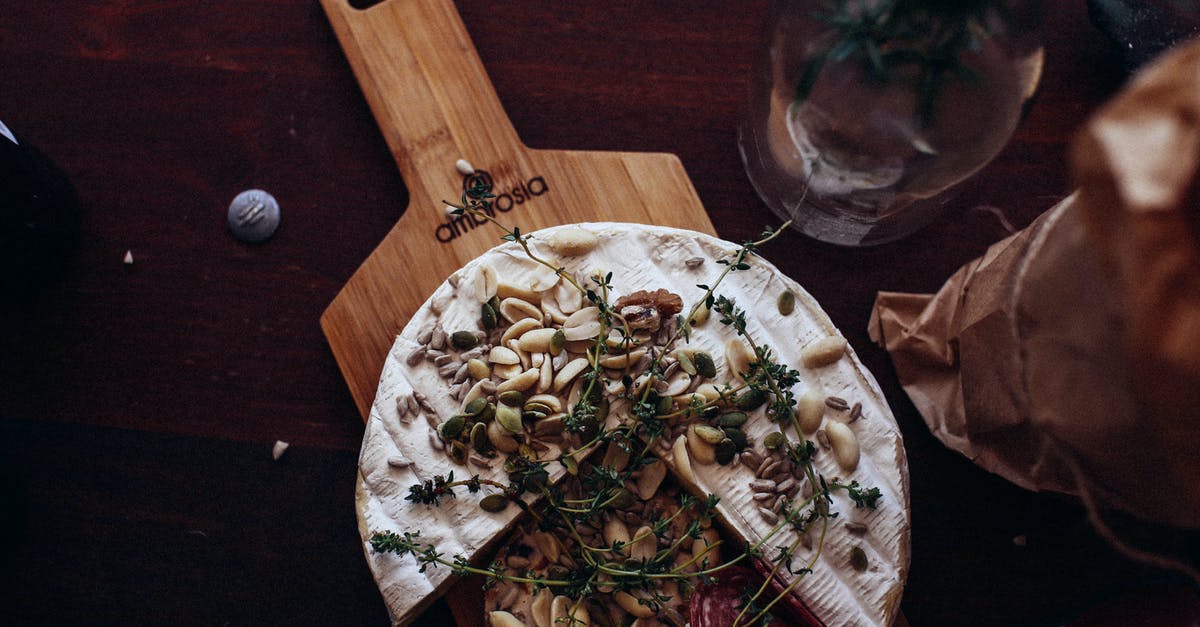 Is a peanut a nut? - Delicious cheese and sausage garnished with nuts and herbs in restaurant Is a peanut a nut? - Delicious cheese and sausage garnished with nuts and herbs in restaurant