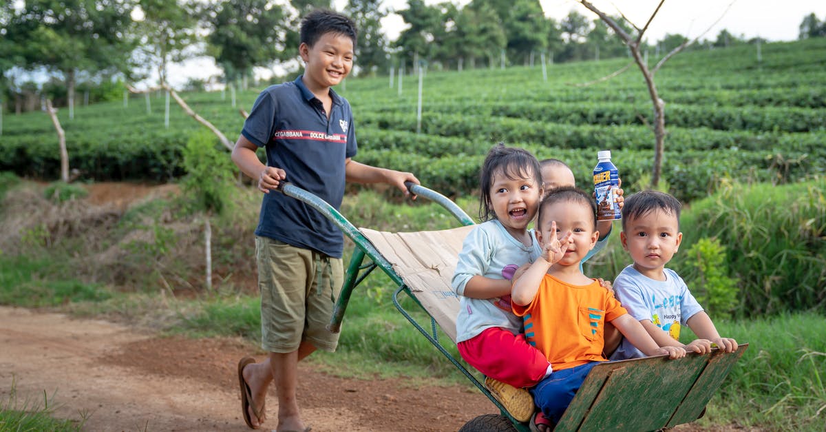 Is butter ever the same after having been melted? - Funny Asian toddlers having fun while brother riding metal wheelbarrow on rural road in green agricultural plantation Is butter ever the same after having been melted? - Funny Asian toddlers having fun while brother riding metal wheelbarrow on rural road in green agricultural plantation