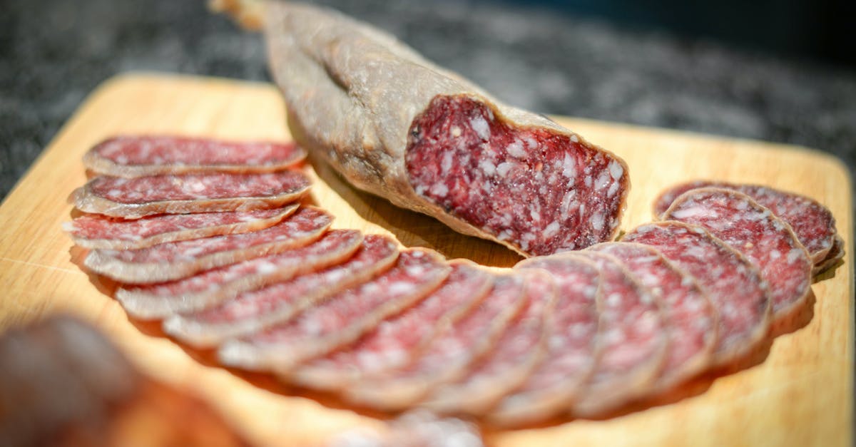Is cured meat broth edible? - Cold cuts of delicious smoked sausage placed on wooden board amidst sausage slices in kitchen Is cured meat broth edible? - Cold cuts of delicious smoked sausage placed on wooden board amidst sausage slices in kitchen