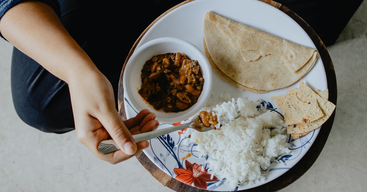 Is eating rice well after its use-by date a bad idea? [duplicate] - Person Using Fork While Eating 
