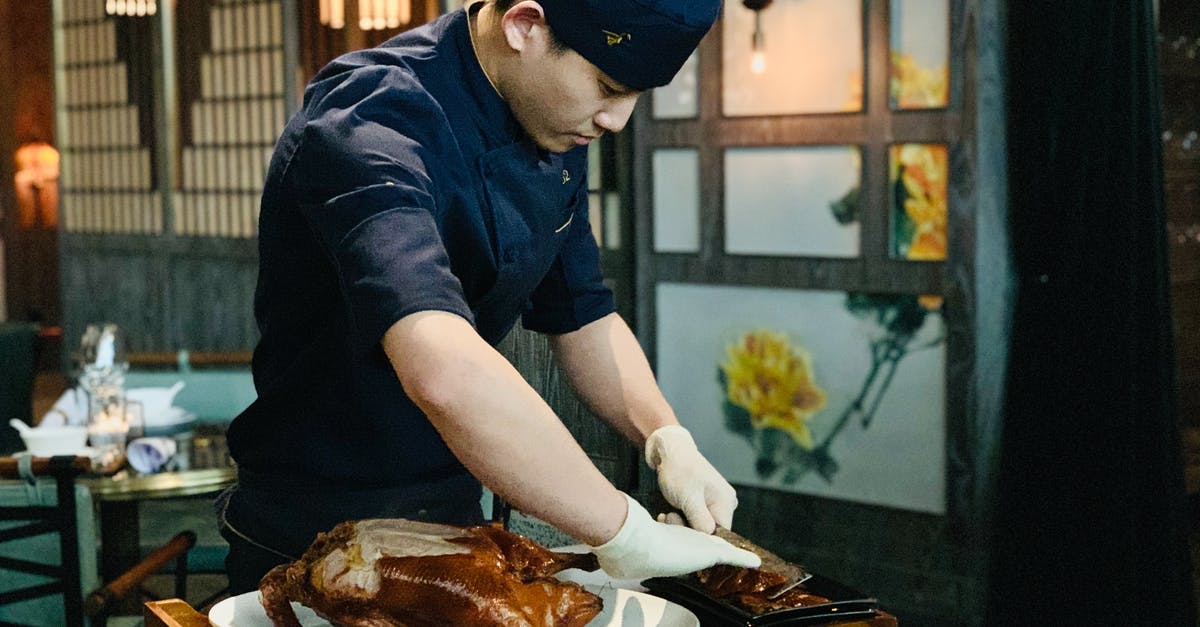 Is extremely young meat indigestible? - Ethnic male cook cutting roasted duck Is extremely young meat indigestible? - Ethnic male cook cutting roasted duck