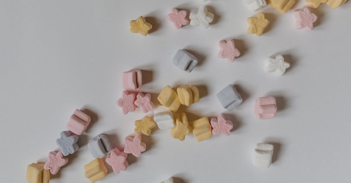Is gelatin vegetarian? - Top view composition of sweet yummy marshmallows in shape of stars scattered on white surface Is gelatin vegetarian? - Top view composition of sweet yummy marshmallows in shape of stars scattered on white surface