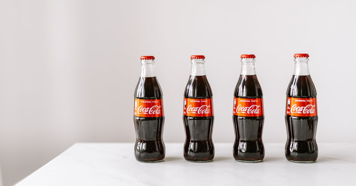 Is granulated sugar (American) the same as caster sugar (UK)? - Glass bottles of cola on white table Is granulated sugar (American) the same as caster sugar (UK)? - Glass bottles of cola on white table
