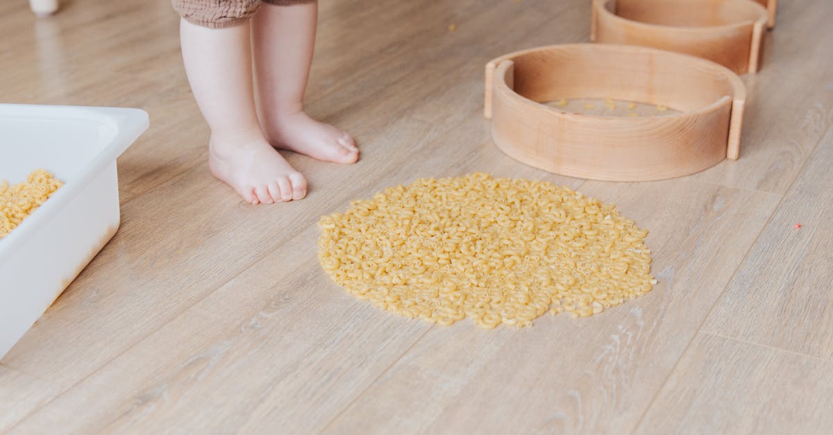 Is great gluten-free extruded pasta possible? - Crop faceless toddler standing barefoot on floor and playing with round wooden shapes of different size and pasta developing fine motor skills at home Is great gluten-free extruded pasta possible? - Crop faceless toddler standing barefoot on floor and playing with round wooden shapes of different size and pasta developing fine motor skills at home