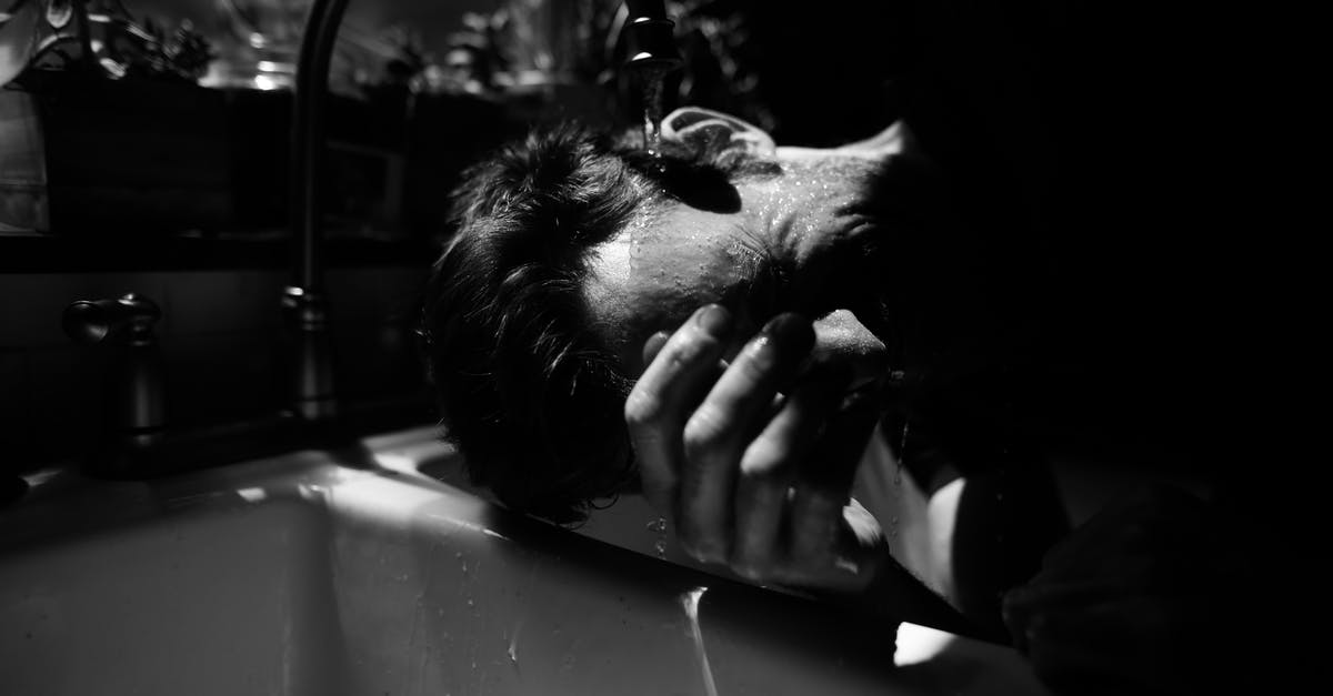 Is hot tap water safe for cooking? - Black and white of unrecognizable male standing near double sink under water flowing from tap in sunny day Is hot tap water safe for cooking? - Black and white of unrecognizable male standing near double sink under water flowing from tap in sunny day