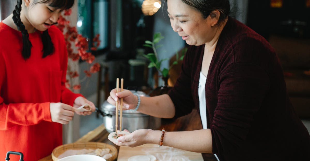 Is Indian food more expensive to prepare than Chinese food? - Crop teenage Asian girl with dark hair helping grandmother to fold traditional Chinese jiaozi dumplings while cooking together in kitchen Is Indian food more expensive to prepare than Chinese food? - Crop teenage Asian girl with dark hair helping grandmother to fold traditional Chinese jiaozi dumplings while cooking together in kitchen