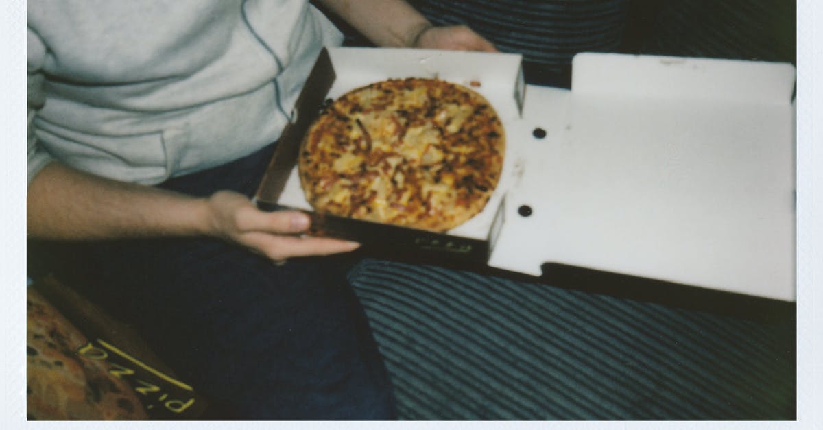 Is it important to let meat sit in oil before grilling/baking? - Person Sitting Holding a Box of Pizza