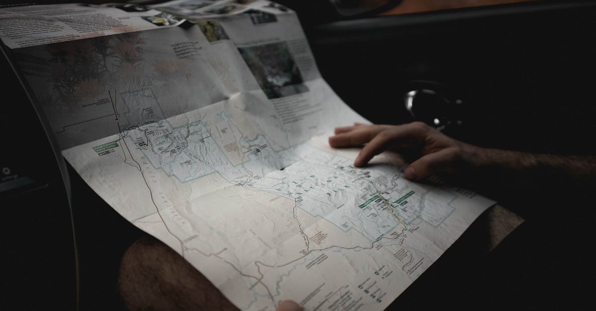 Is it normal to find something in tea? - Crop man with map in automobile Is it normal to find something in tea? - Crop man with map in automobile