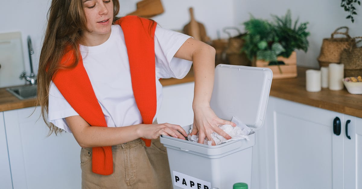 Is it okay to throw the food, collected in the mesh in the sink, down the drain, if it doesn't contain plastic? [closed] - Happy woman sorting trash in bin