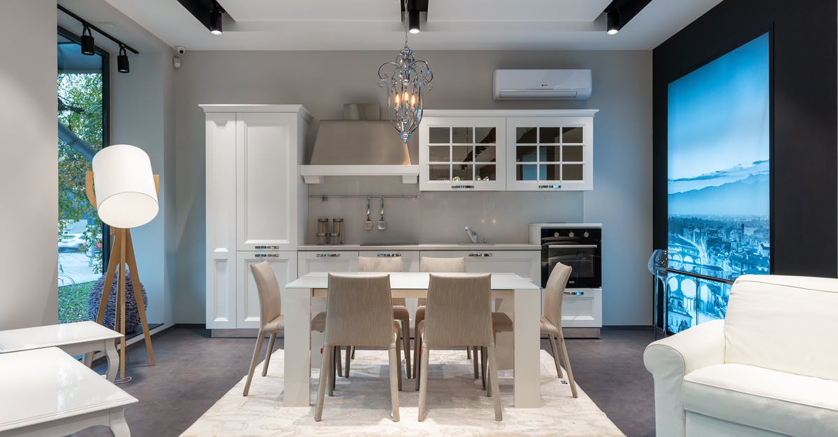 Is it possible to extract the allergens from shellfish? - Chairs at table placed on rug near white cupboards and modern appliances at stylish kitchen with window and glowing lamp Is it possible to extract the allergens from shellfish? - Chairs at table placed on rug near white cupboards and modern appliances at stylish kitchen with window and glowing lamp