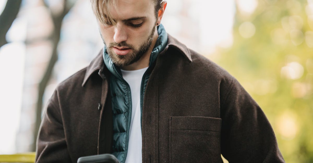 Is it possible to get veal that is not incredibly fatty? - Young hipster looking at smartphone screen in park Is it possible to get veal that is not incredibly fatty? - Young hipster looking at smartphone screen in park