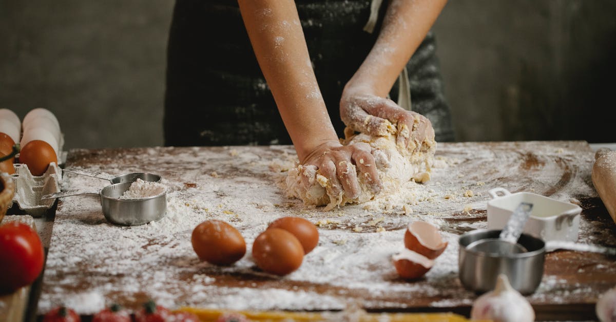 Is It Possible to Make Elbow Pasta At Home? - Crop chef kneading dough on wooden board Is It Possible to Make Elbow Pasta At Home? - Crop chef kneading dough on wooden board