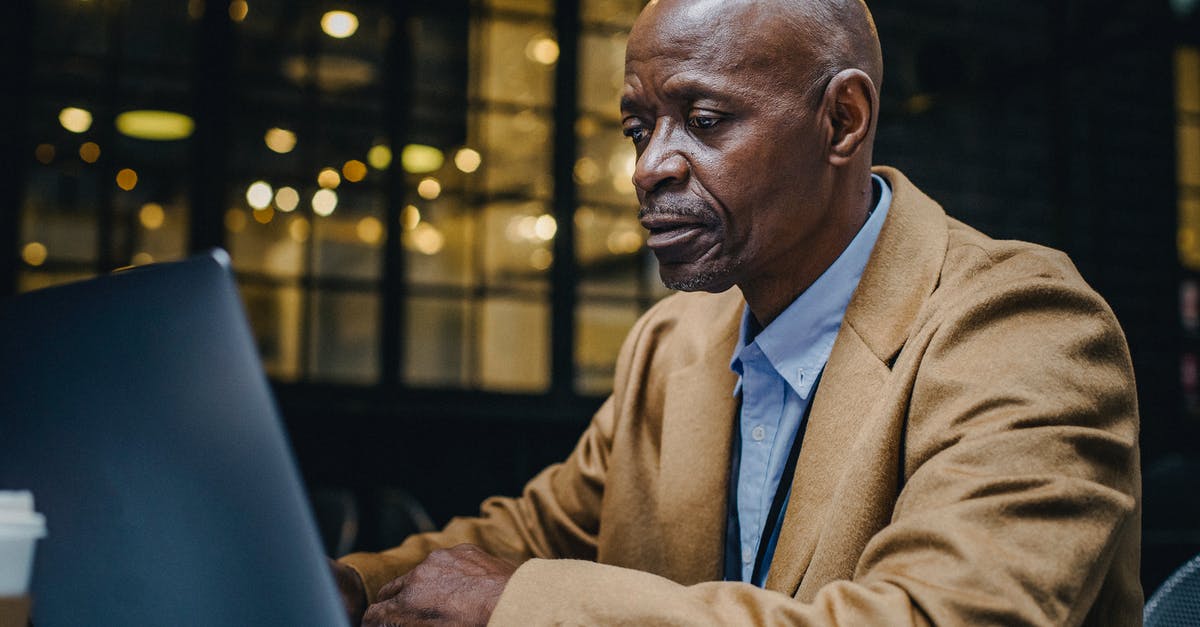 Is it possible to mature shop-bought hard cheese? - Focused mature African American businessman in suit surfing internet on netbook at table in cafeteria Is it possible to mature shop-bought hard cheese? - Focused mature African American businessman in suit surfing internet on netbook at table in cafeteria