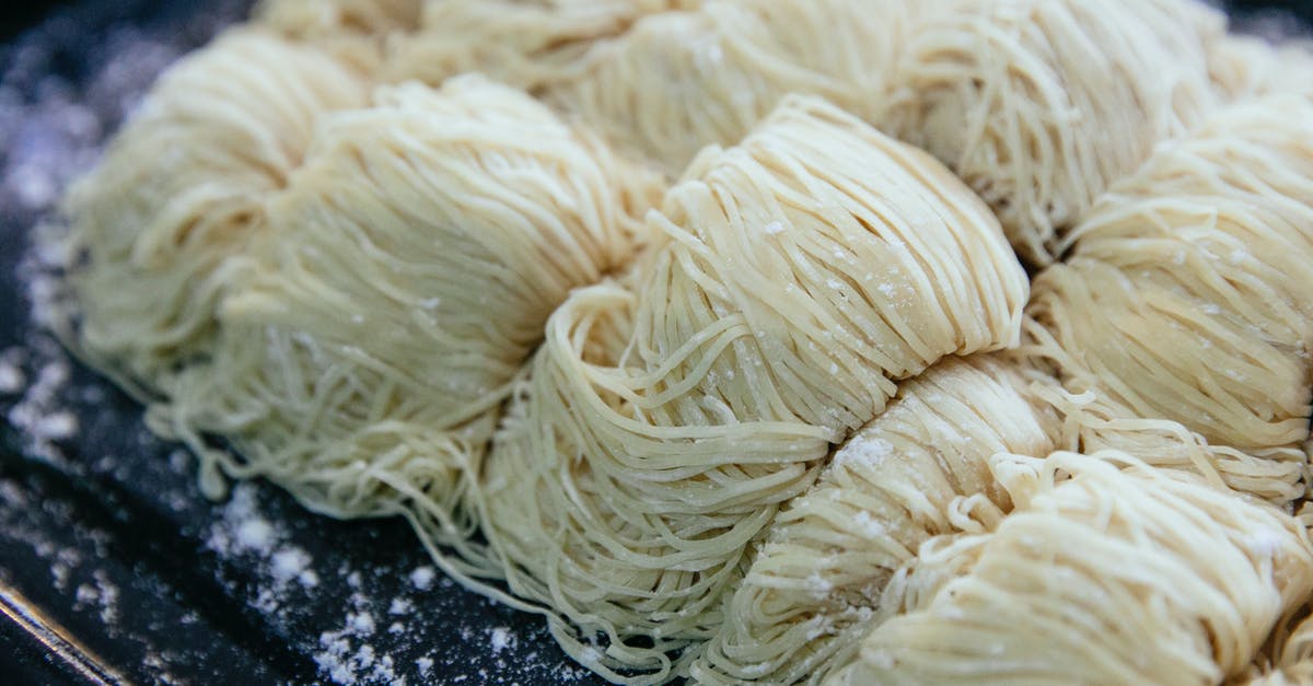 Is it possible to use casserole dish to make no-knead bread? - Homemade egg noodles collected in rolls and sprinkled with flour on black baking sheet Is it possible to use casserole dish to make no-knead bread? - Homemade egg noodles collected in rolls and sprinkled with flour on black baking sheet
