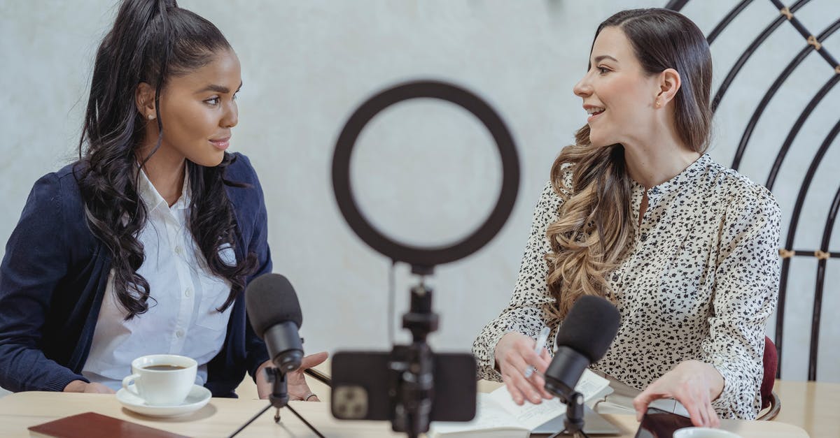 Is it possible to use Coffee Mill for other grain? - Positive blogger asking questions to African American speaker and recording interview on cellphone at table with microphones