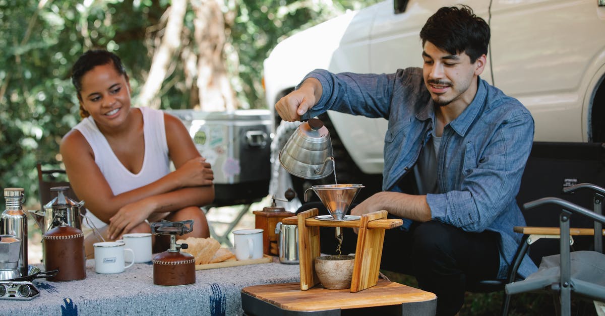 Is it practical to boil drinking water in a pressure cooker? - Happy diverse couple preparing pour over coffee in campsite Is it practical to boil drinking water in a pressure cooker? - Happy diverse couple preparing pour over coffee in campsite