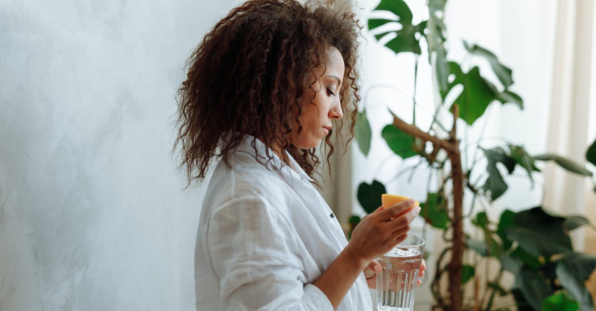 Is it safe to boil lemon water? - Side View of a Woman Holding a Glass of Water and a Slice of Lemon Is it safe to boil lemon water? - Side View of a Woman Holding a Glass of Water and a Slice of Lemon