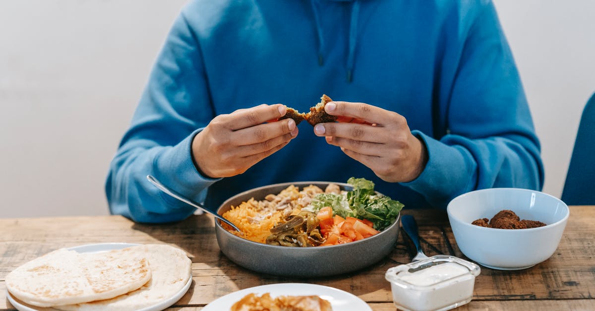 Is it safe to eat white rice that turned blue/purple in the fridge? - Man eating delicious meat at table with national dish Is it safe to eat white rice that turned blue/purple in the fridge? - Man eating delicious meat at table with national dish