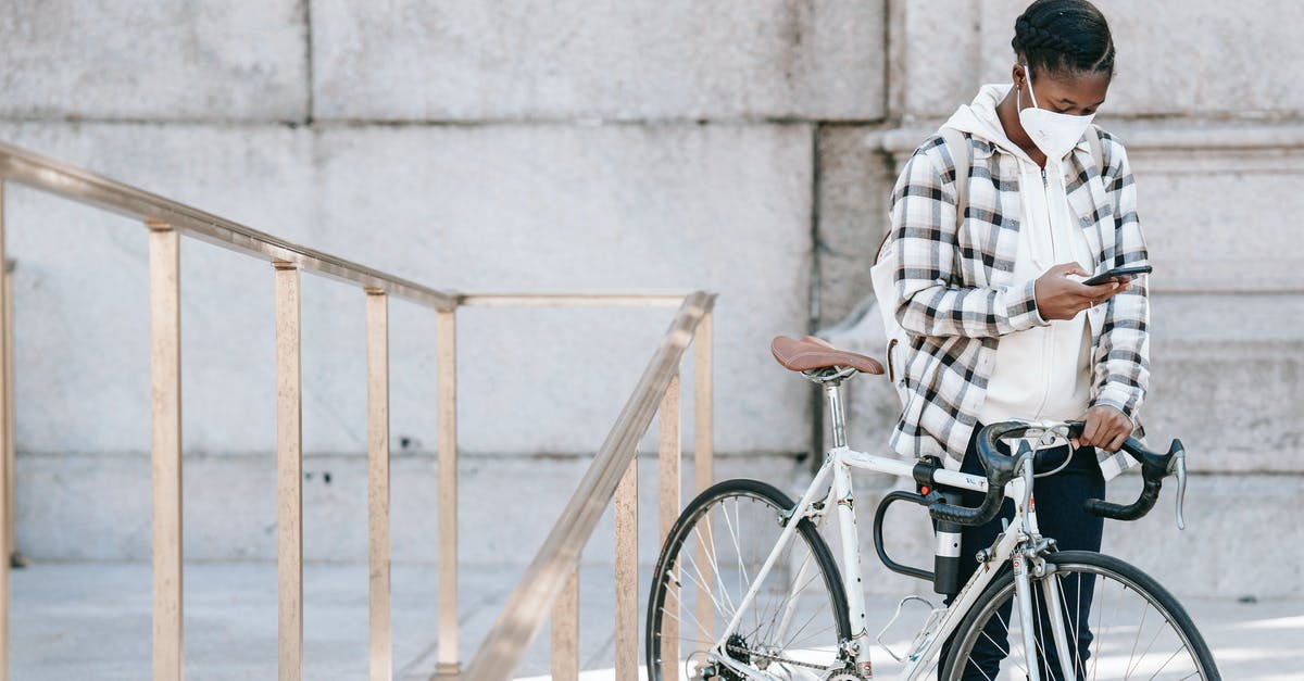Is it safe to make extracts from stone fruit pits? - African American woman with smartphone and bicycle
