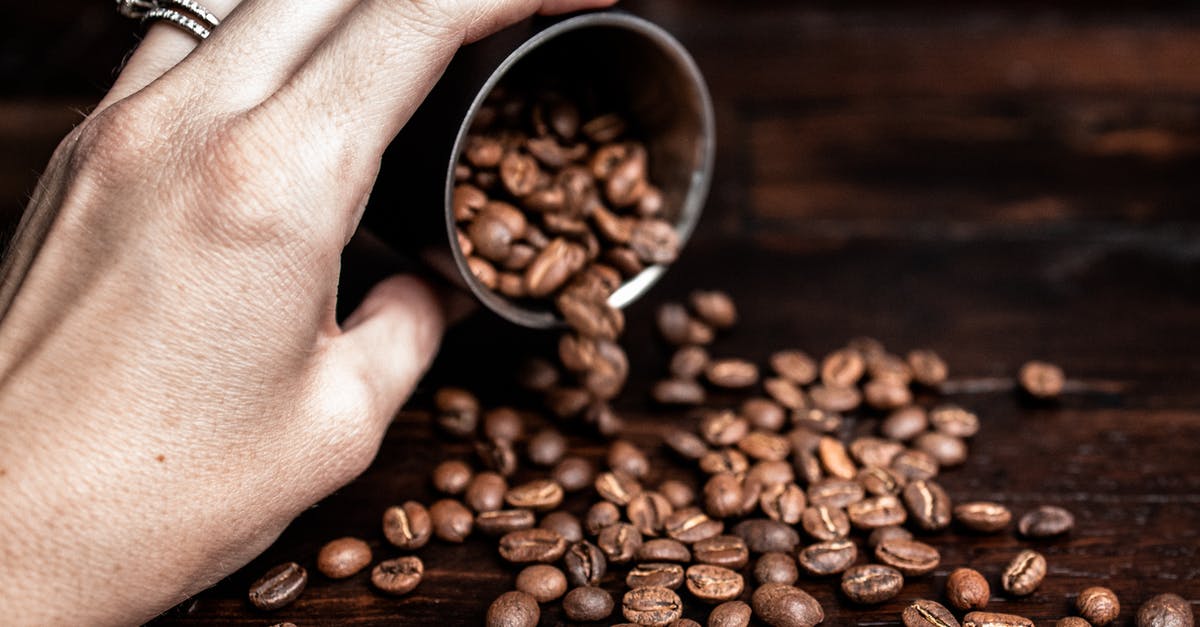 Is it true that smell is lost flavor? - Woman pouring coffee beans on table Is it true that smell is lost flavor? - Woman pouring coffee beans on table