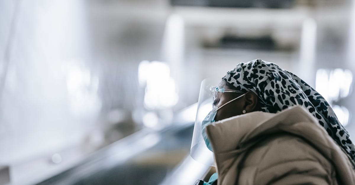 Is jerky safe concerning parasites? - Black woman in face shield and mask standing near escalator Is jerky safe concerning parasites? - Black woman in face shield and mask standing near escalator