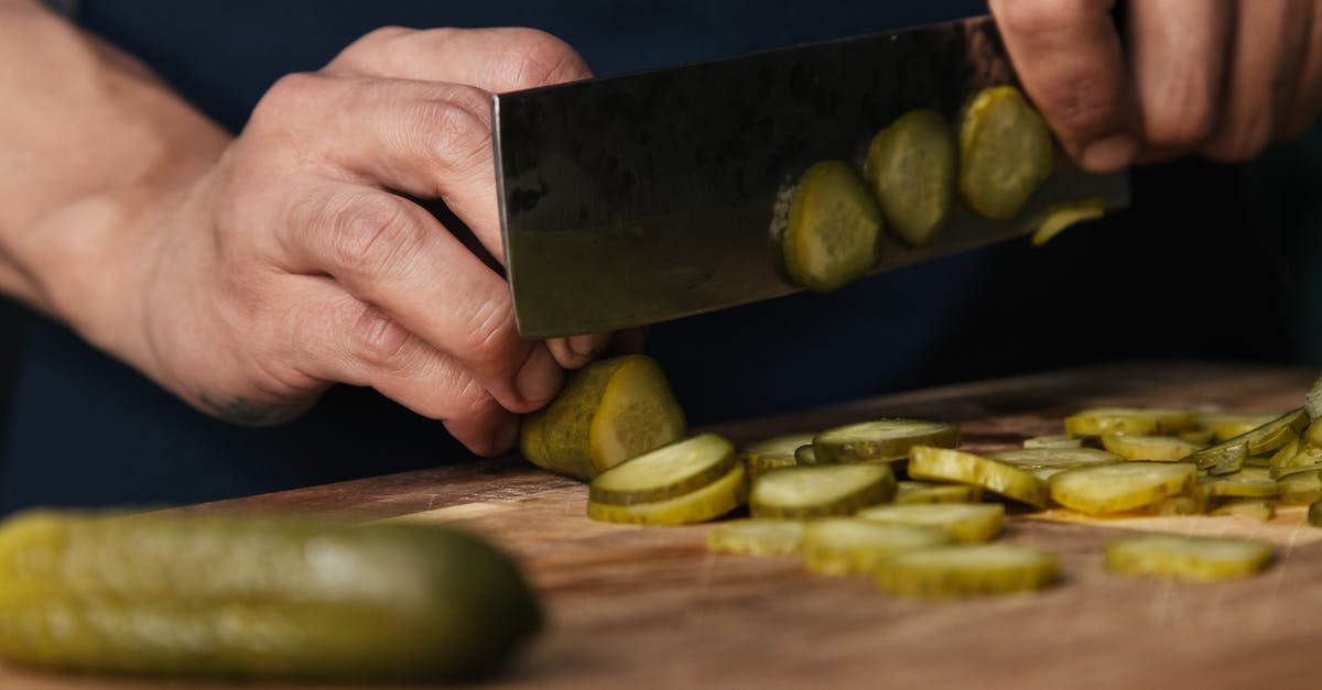 Is pickled herring cooked? - Person Slicing Pickles on a Wooden Chopping Board Is pickled herring cooked? - Person Slicing Pickles on a Wooden Chopping Board