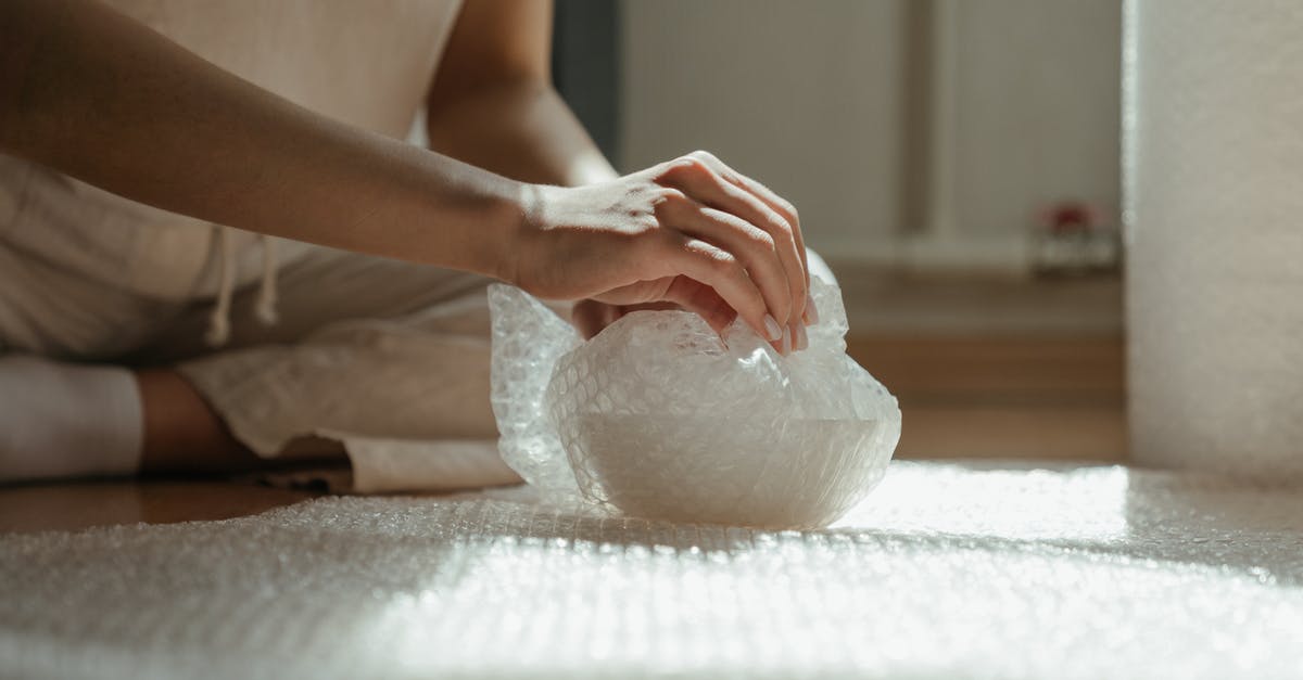 Is plastic wrap safe to use when tempering chocolate? - Person Holding White Plastic Bag Is plastic wrap safe to use when tempering chocolate? - Person Holding White Plastic Bag