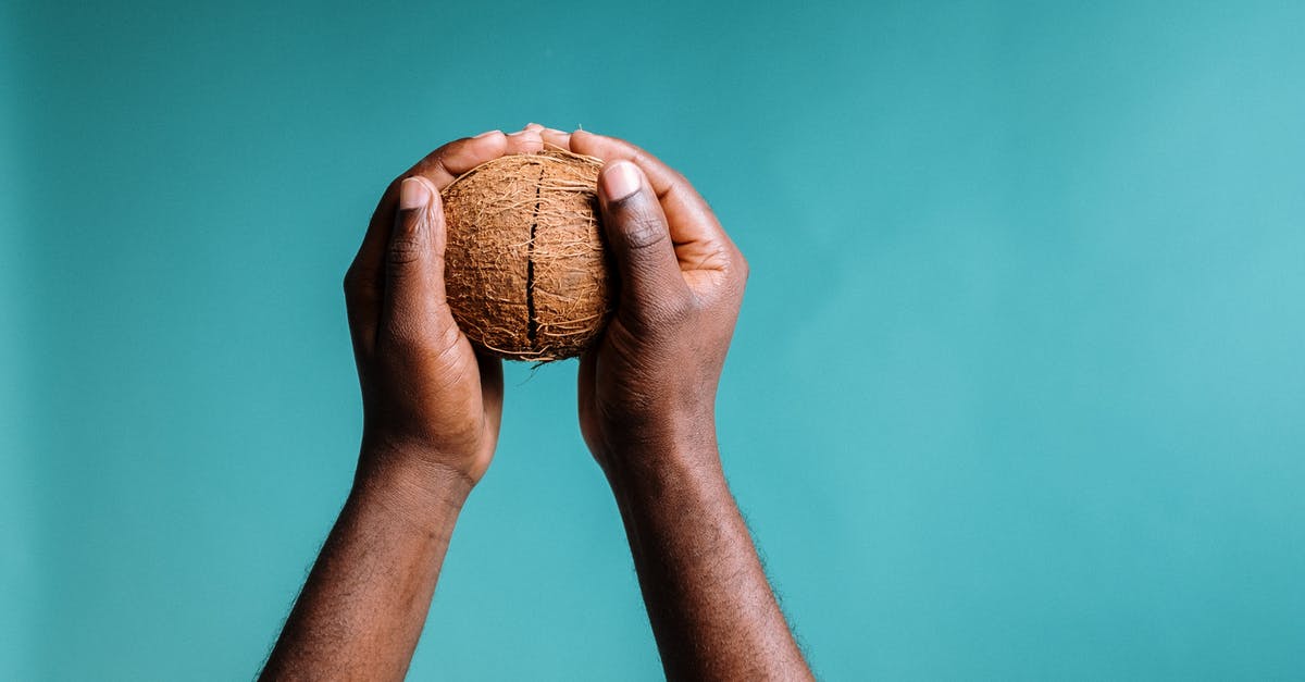 Is raw coconut safe to eat? - Photo Of Person Holding Sliced Coconut Is raw coconut safe to eat? - Photo Of Person Holding Sliced Coconut