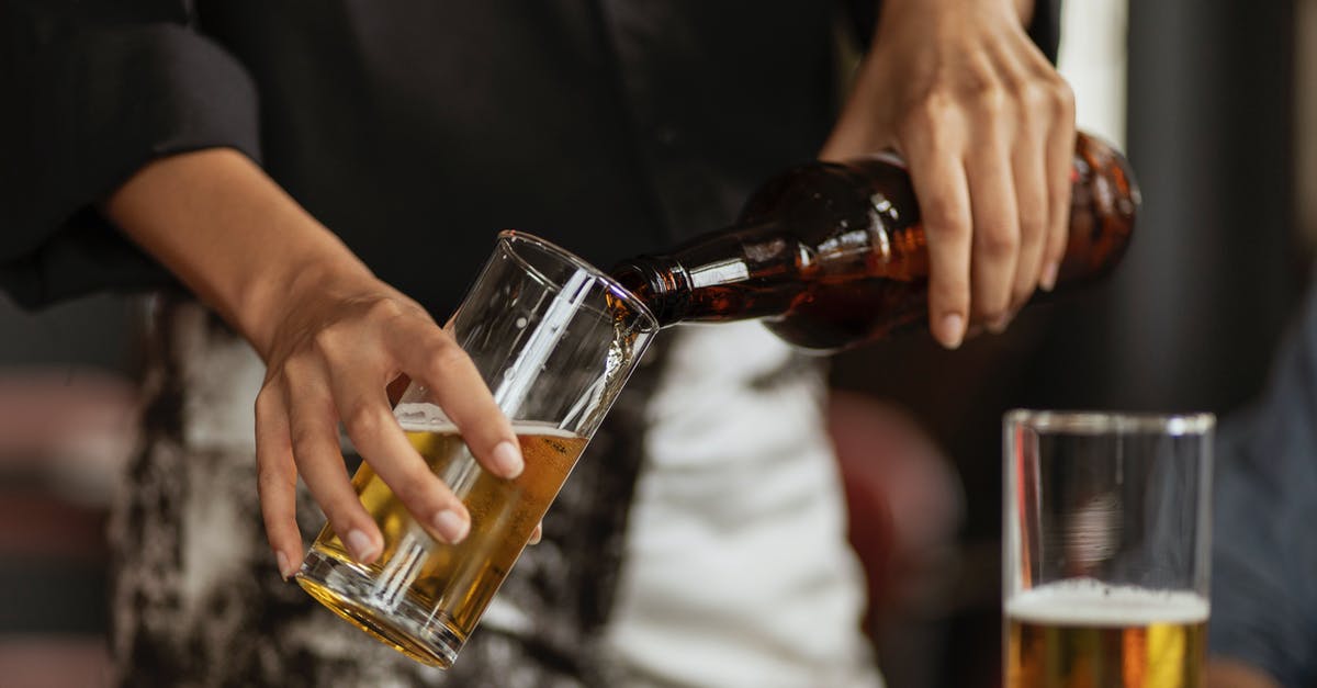 Is the pouring method of beer really important? - A Person Pouring Beer on a Clear Drinking Glass Is the pouring method of beer really important? - A Person Pouring Beer on a Clear Drinking Glass